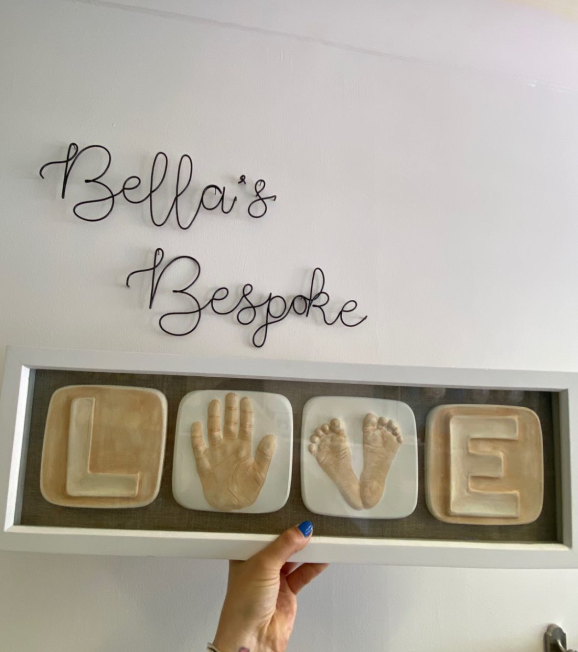LOVE frame with a handprint and footprint as the O and V