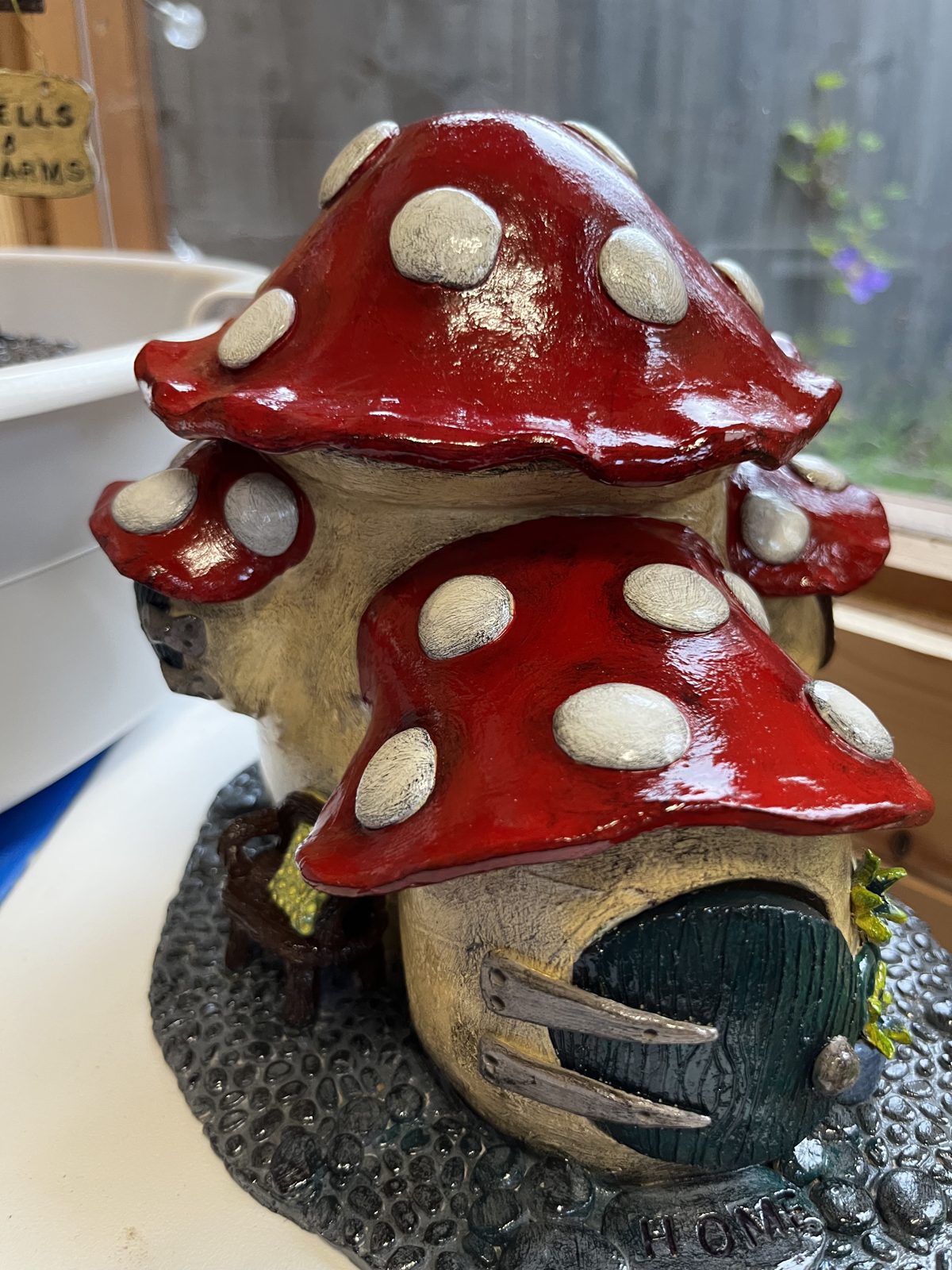 Red-capped ceramic mushroom fairy house
