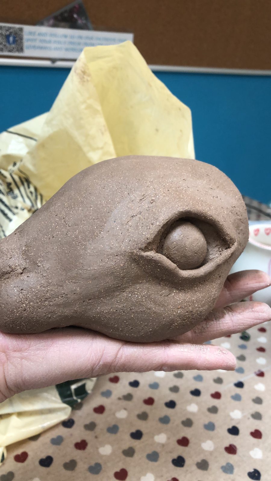 Clay whale held in one hand
